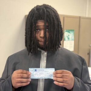 Kevin holds up a check from his first investor