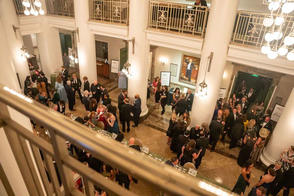 Overhead view of 100+ guests in formal wear in the Schermerhorn lobby