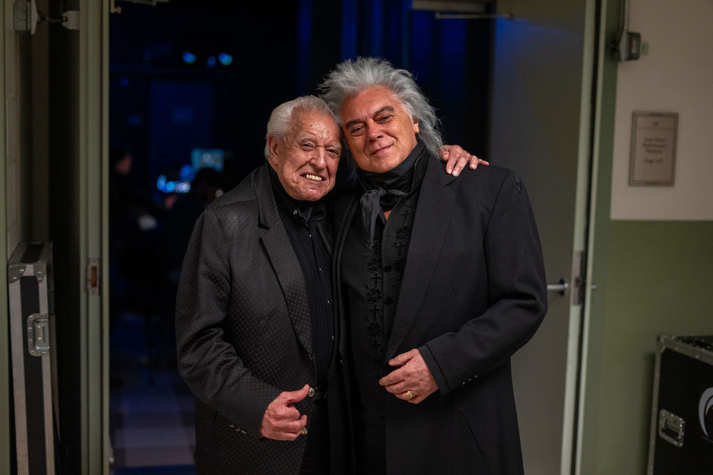 Two men embracing backstage, Hall of Fame inductees