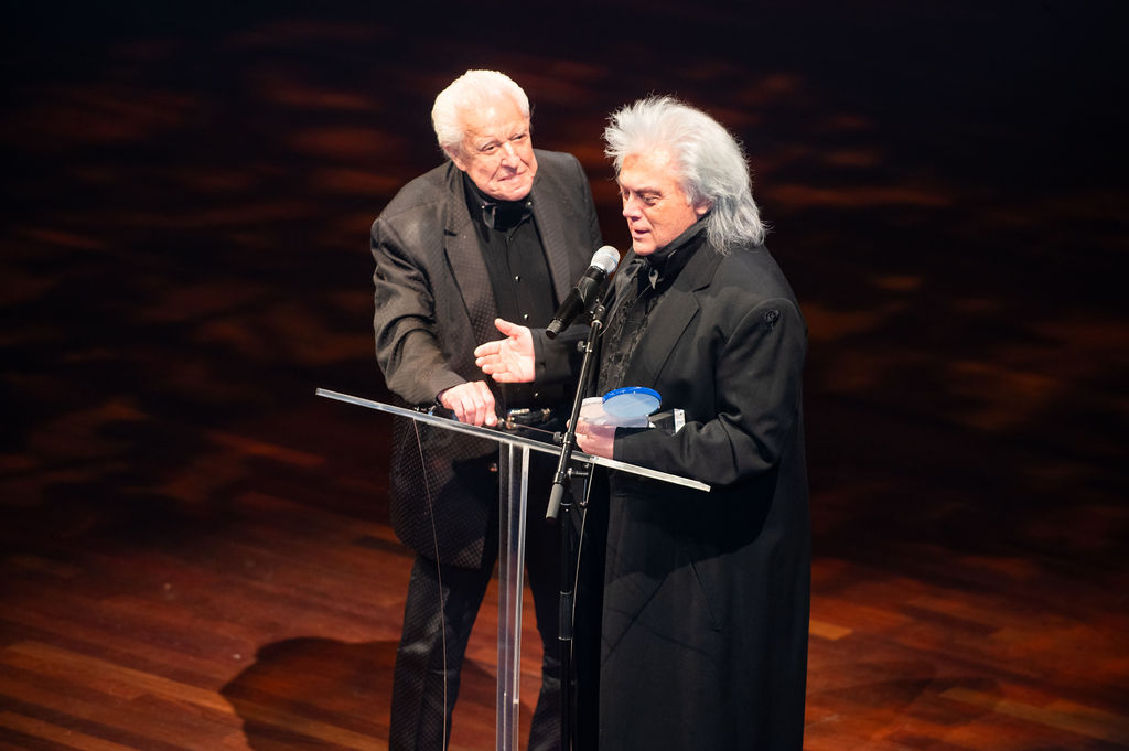 Recipients embracing on stage