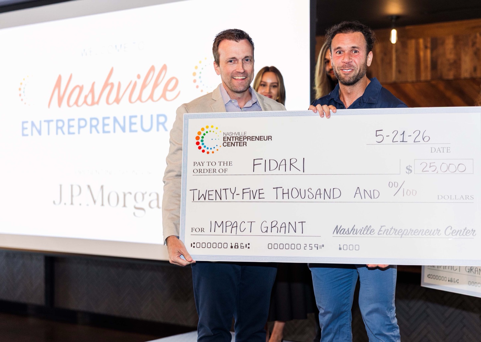 Founders receiving a $25,000 impact grant check at Nashville Entrepreneur Day
