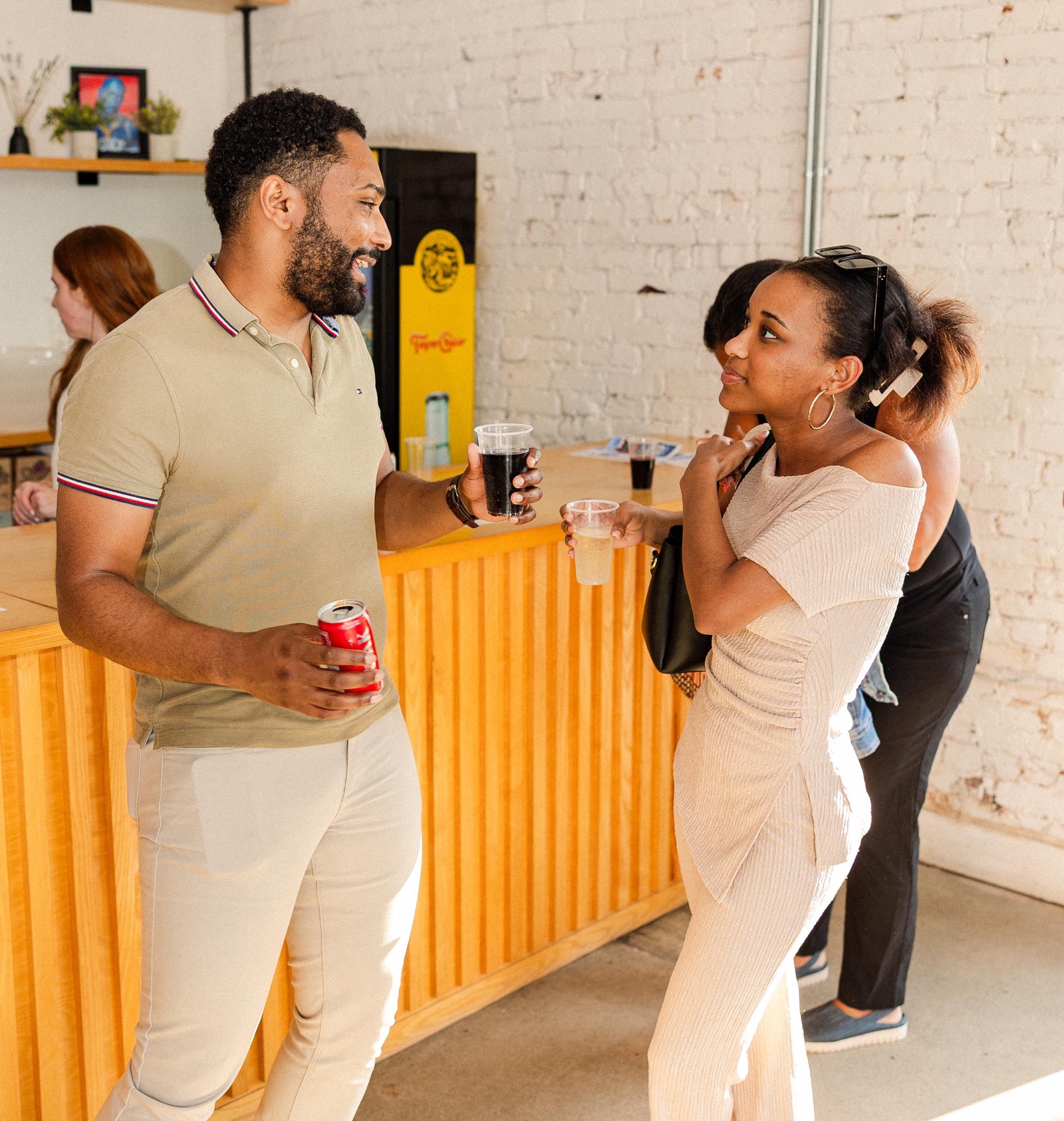Two founders talking at the bar during the Founders of Color happy hour