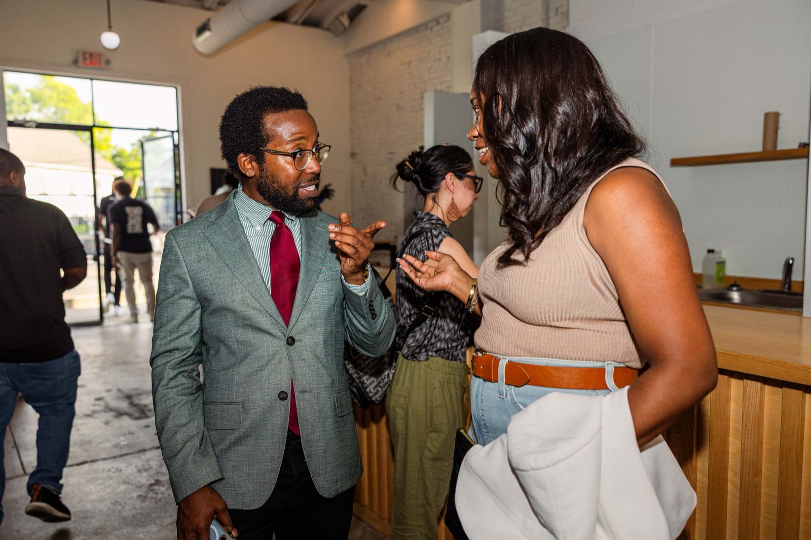 Two founders deep in conversation at the Founders of Color happy hour