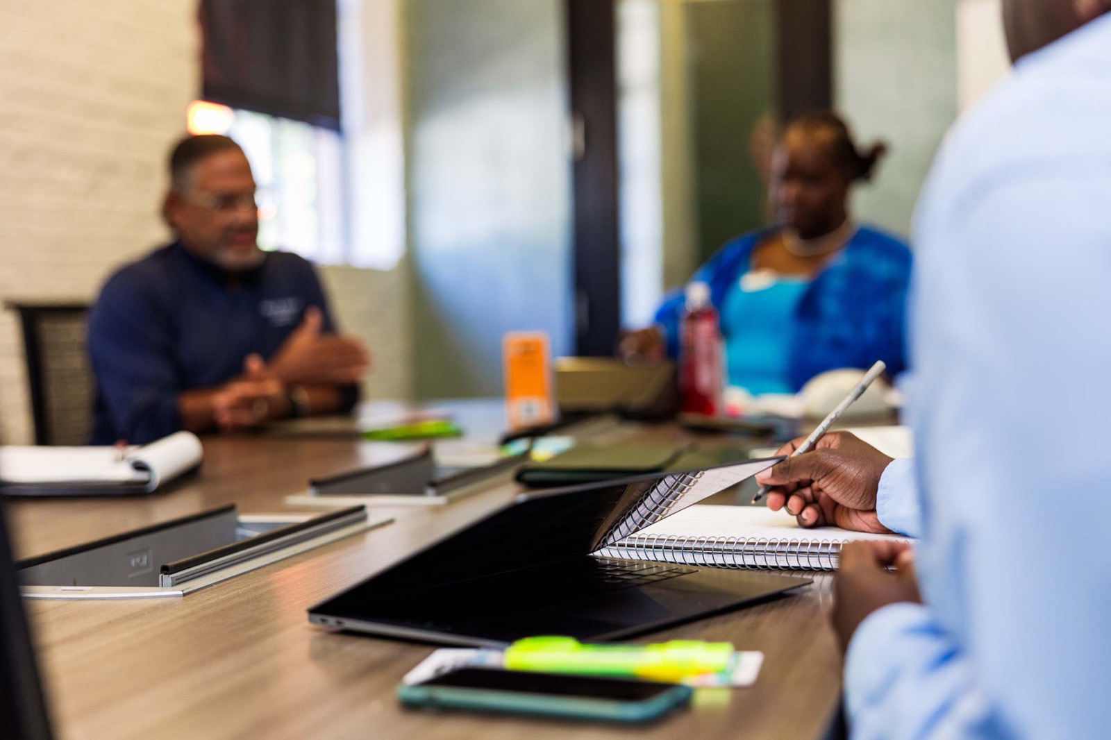 A founder taking notes during a peer group session