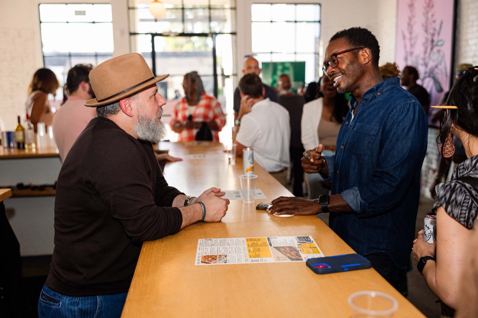 Founders Circle members in conversation at a happy hour