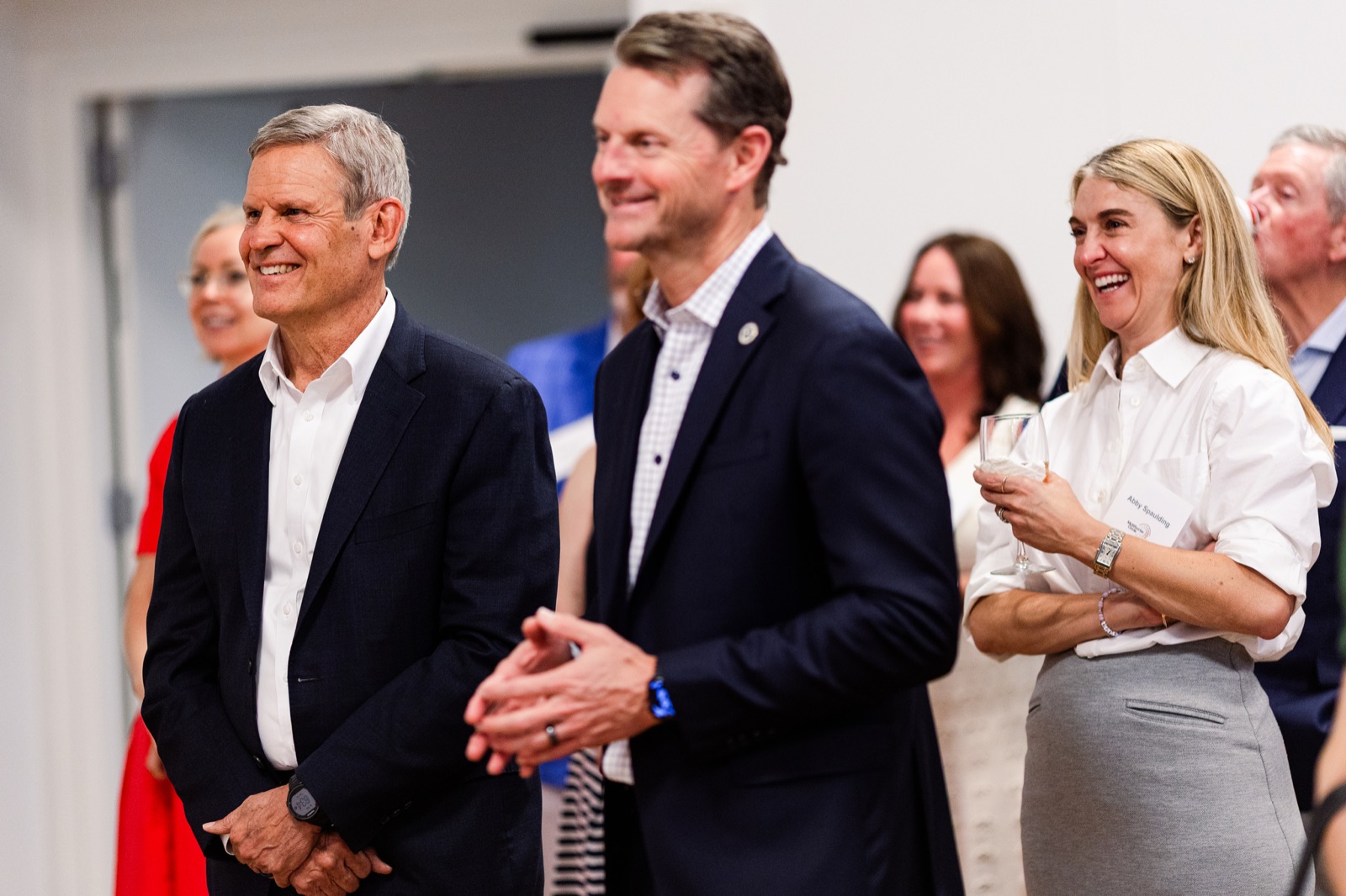 Guests laughing together while listening to remarks