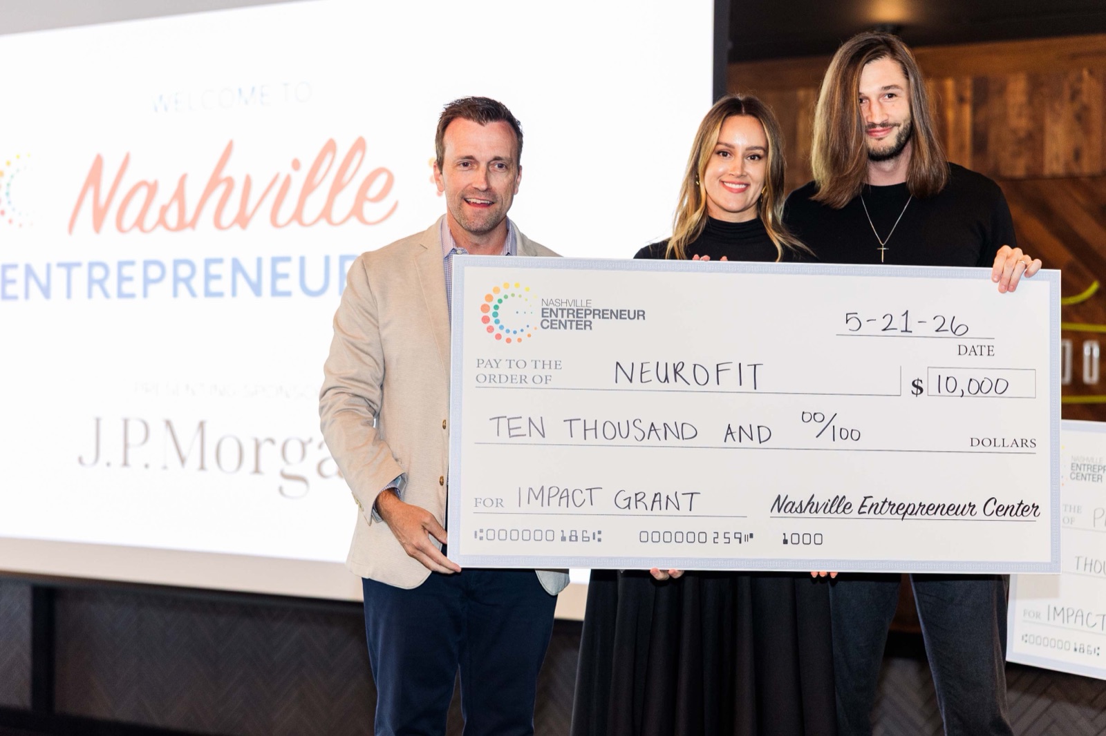 Founders accepting an Impact Grant on stage at Nashville Entrepreneur Day