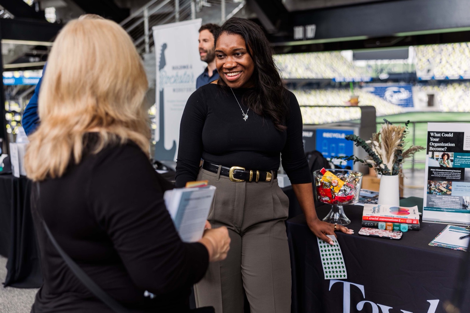A founder talking with an attendee at her expo booth