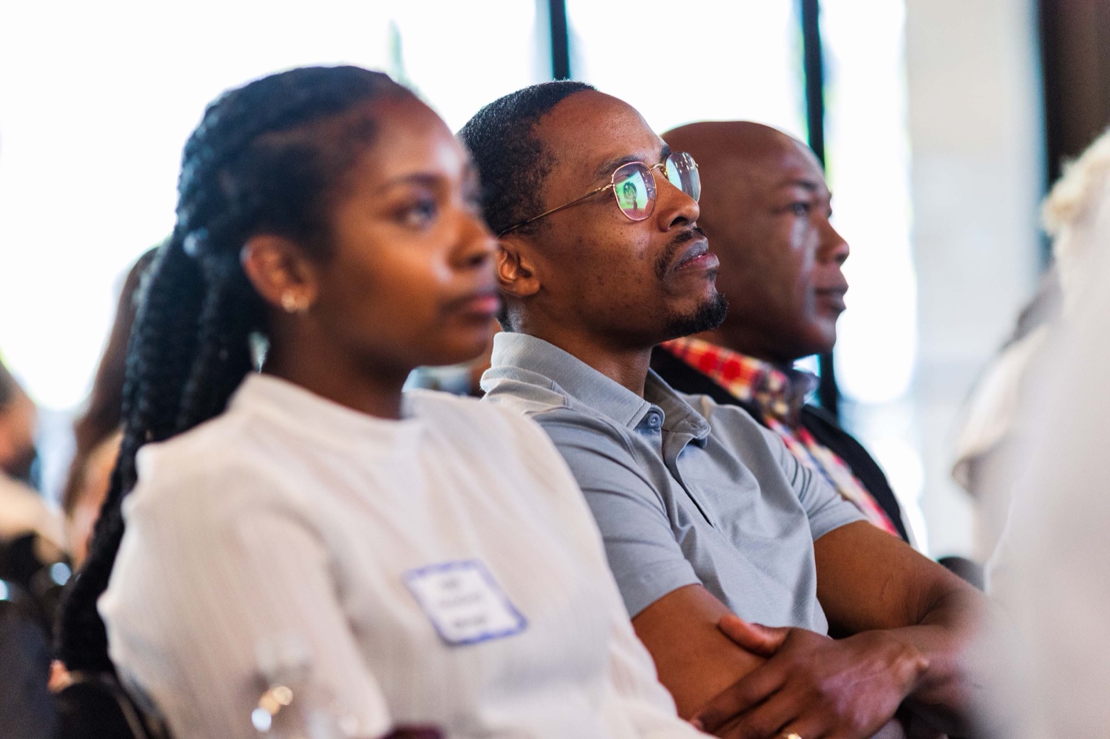 Attendees watching a pitch attentively from their seats