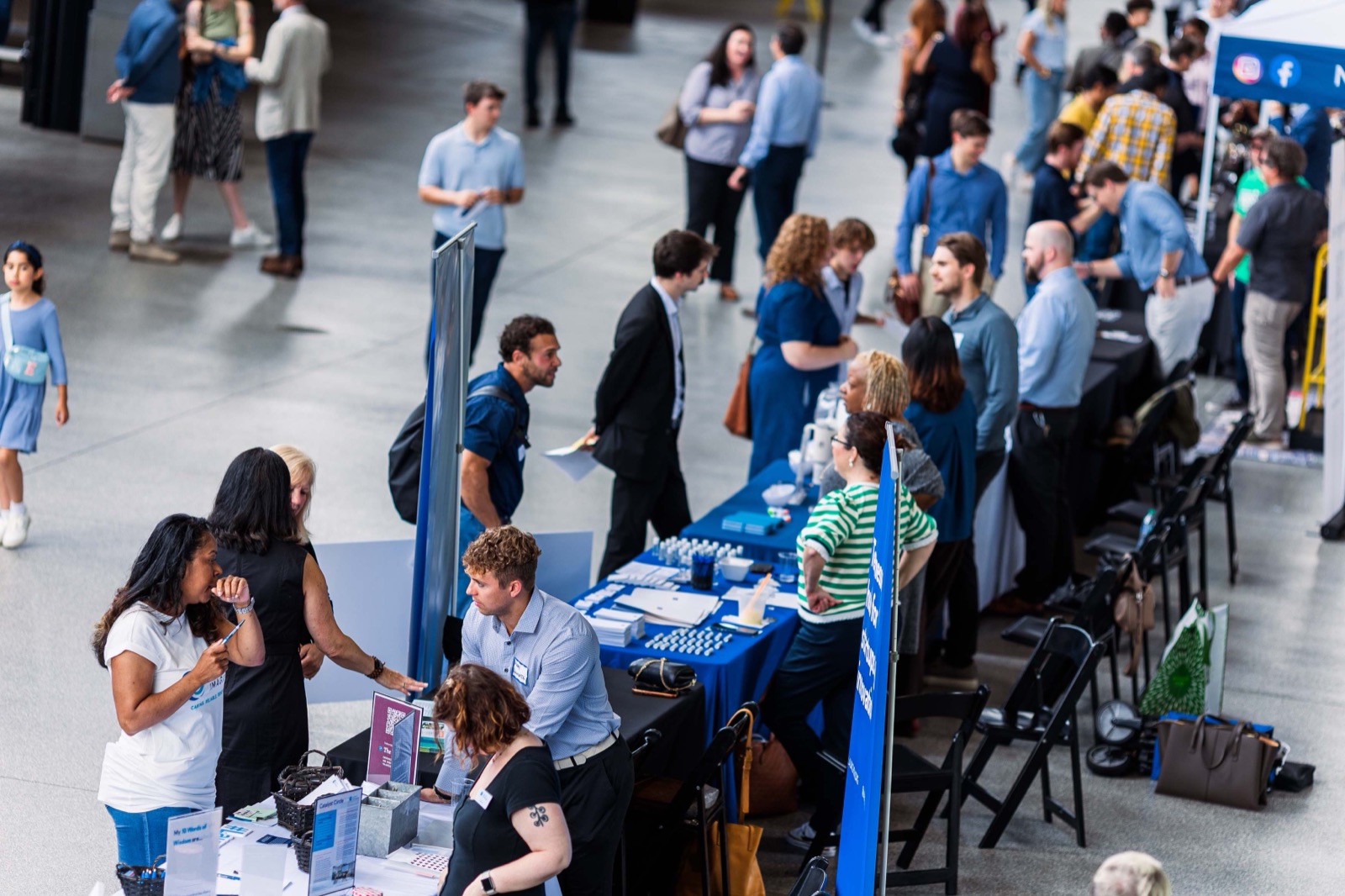Rows of founder expo booths with attendees walking between them at Nashville Entrepreneur Day