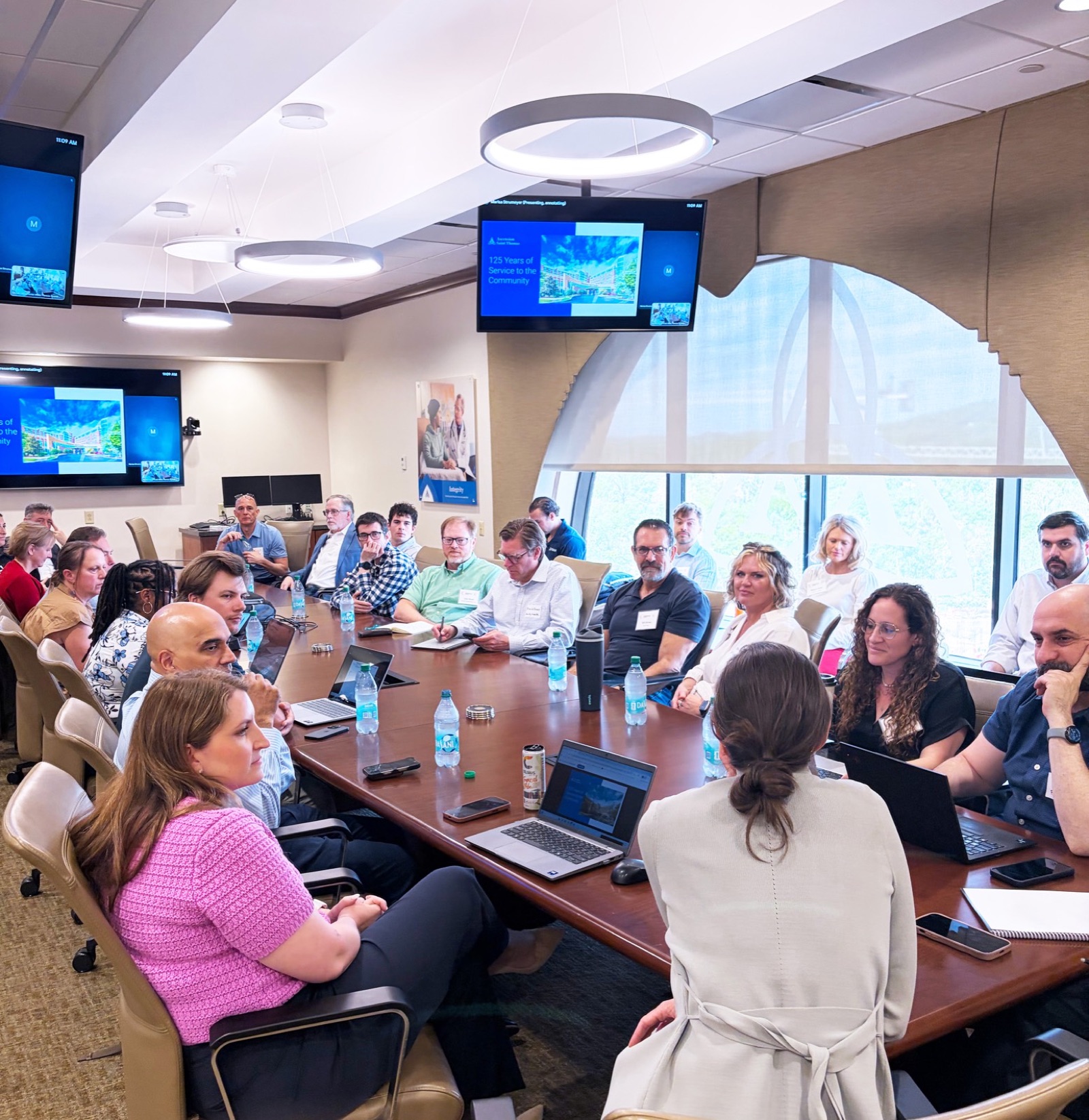 Project Healthcare founders inside a health system boardroom during an immersion visit