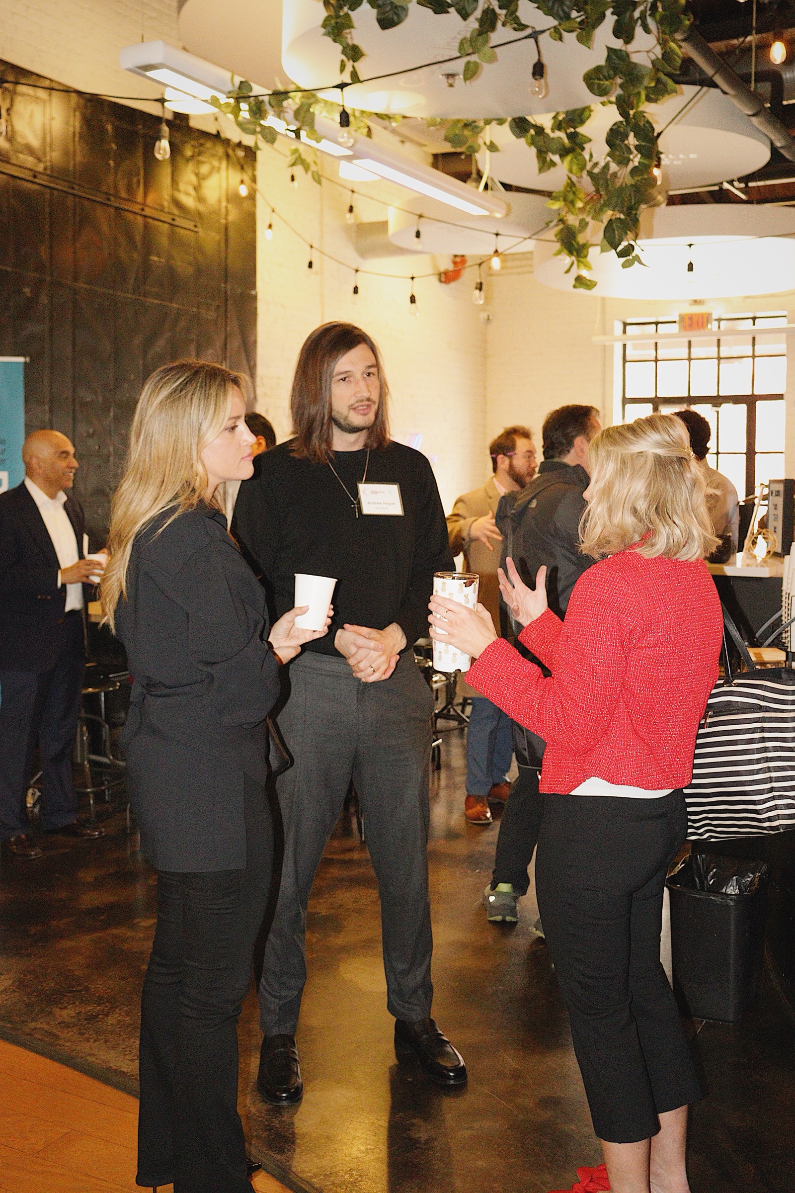 Founders and an advisor talking over coffee at the EC