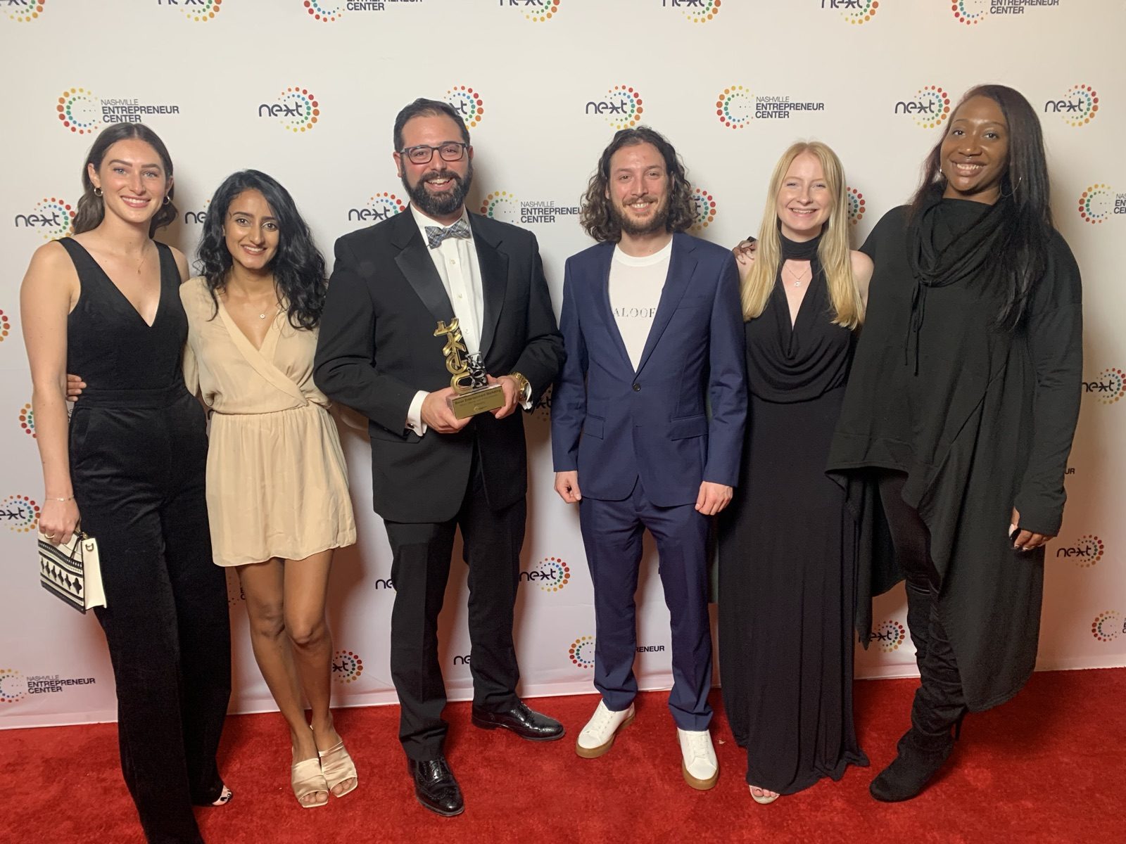 The Bauer Entertainment Marketing team on the red carpet holding the 2021 NEXT Award