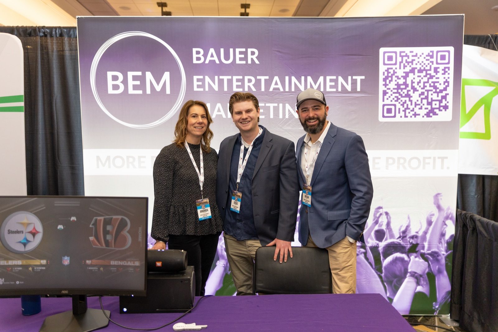 Brian Bauer and two BEM teammates at a Bauer Entertainment Marketing trade show booth